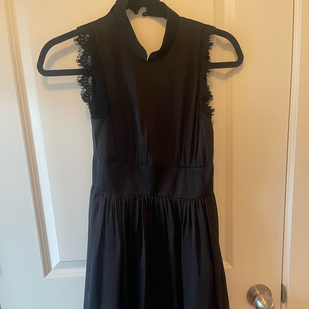 Corey Lynn Carlter black open back dress with lace sleeve